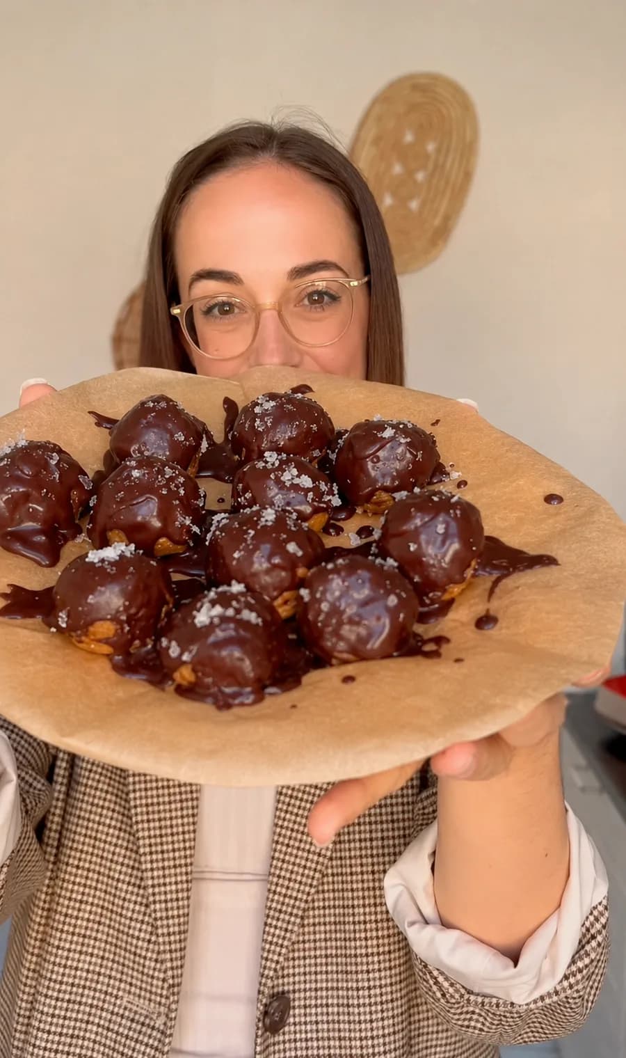 Brigitte Riedl holding a tray of chocolate-covered energy balls